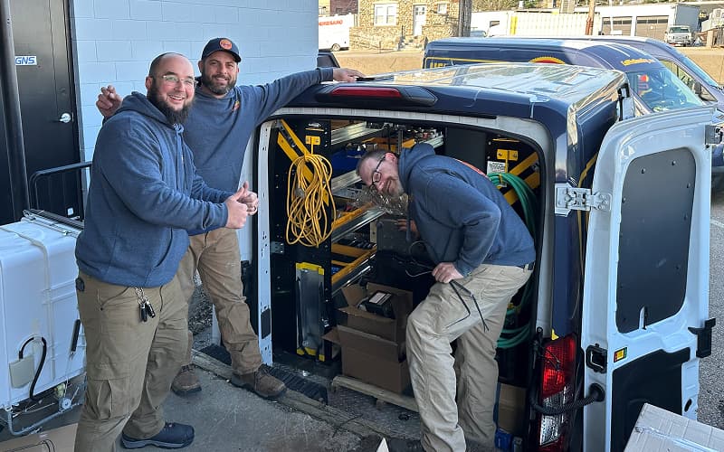 The Yellow Dog team beside their service van