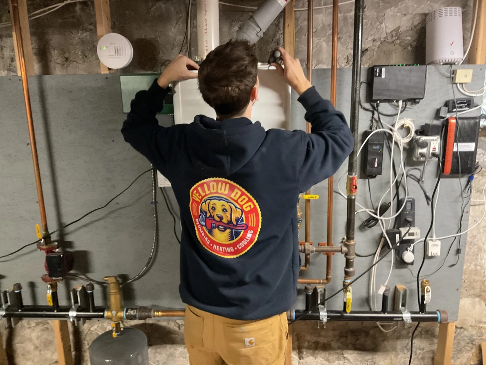 Yellow Dog technician installing an HVAC system